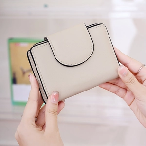 Close-up of a compact women's bifold wallet in cream with black contrast edge finishing