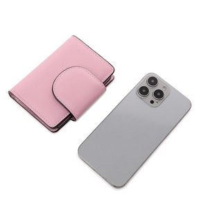 Detail of pink lychee leather folding wallet with curved flap and snap button closure