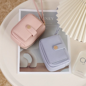 Close-up of litchi texture PU leather coin purse with gold buckle and wristlet strap