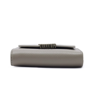Close-up of litchi grain texture and stitching on a taupe foldable PU leather wallet