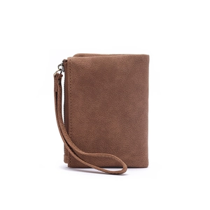 Detailed macro view of brown frosted leather wallet texture with wrist strap and zipper