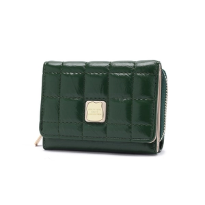 Macro detail of dark green quilted leather wallet with gold metal logo and zipper