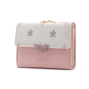 Detail of Prettyzys pink trifold wallet with leaf print and gold clasp closure