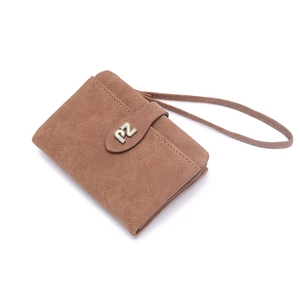 Detail of caramel brown fold wallet with wrist strap and metal logo accent