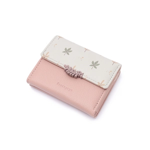 Close-up of pink bi-fold wallet with leaf pattern and textured synthetic leather detail