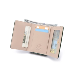 Detail view of tri-fold leather wallet showing card slots and pink interior texture