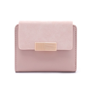 Detail of a dusty pink short wallet featuring a textured gold metal buckle and matte finish