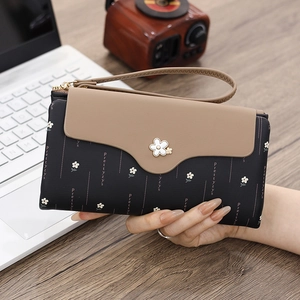 Close-up of long floral wallet with metal flower clasp and textured PU leather