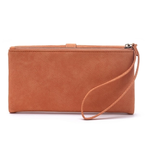 Macro view of terracotta faux suede long wallet showing smooth zipper and wrist strap detail
