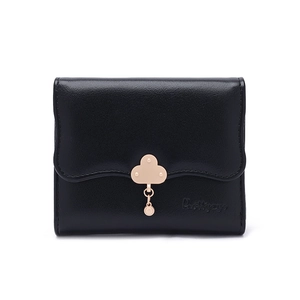 Close-up of black tri-fold wallet with scalloped edge flap and gold cloud pendant