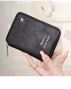 Detailed shot of black travel passport wallet with zipper and textured leather finish