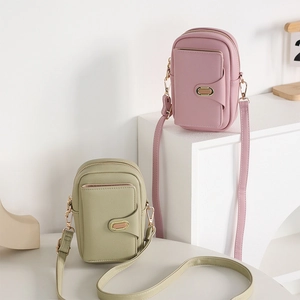 Close-up of litchi texture PU leather phone waist bags in pink and green colors