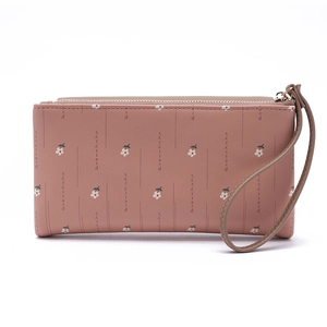 Detail of dusty rose pink floral wallet with metal zipper and wrist strap feature