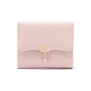 Close-up of light pink wallet with wave-edge flap and golden cloud charm buckle detail