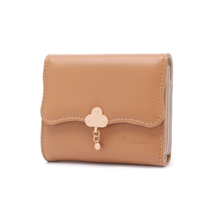 Detail of warm brown wallet with cloud-shaped gold hardware and brand logo