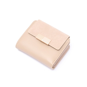 Detail view of beige tri-fold wallet with gold clasp and textured flap closure