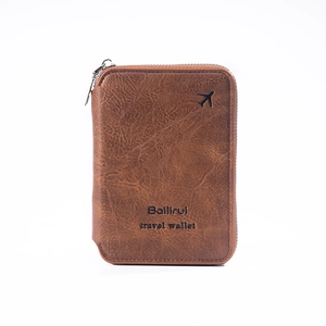 Close-up of a brown vintage travel passport wallet with zipper and airplane motif
