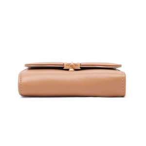 Side view of a tri-fold brown leather wallet featuring white stitching and gold clasp