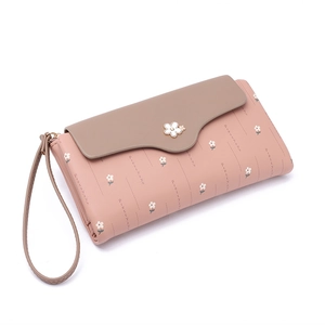 Close-up of pink long wallet with floral print and buckle detail for women