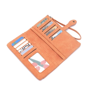 Detailed interior of long orange wallet showing 11 card slots and ID window