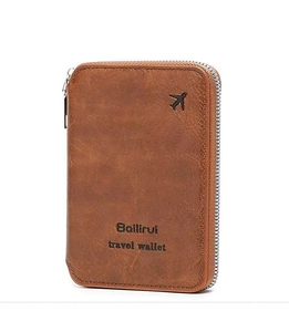 Close-up of brown textured leather travel wallet with gold airplane icon and secure zipper