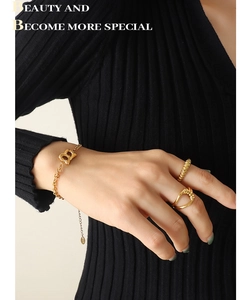 Detailed view of 18K gold plated Cuban chain bracelet with B letter pendant and rings