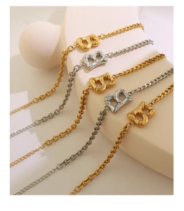 Detail showing gold and silver Cuban link bracelets with textured Bamboo B pendants