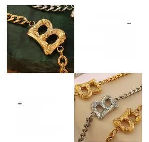 Macro shot of gold-plated 18K titanium steel letter B charm with bamboo texture finish