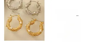 Close-up of hammer-textured U-shape earrings with inlaid pearls and sparkling zircons
