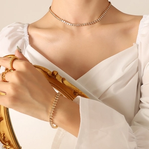 Elegant gold-tone tennis necklace and bracelet set with sparkling cubic zirconia on model