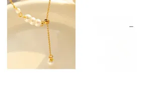 Detailed macro view of minimalist faux pearl necklace with gold-plated adjustable chain link