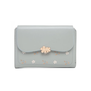 Detail of floral print on light blue wallet with golden flower metal clasps and stitching