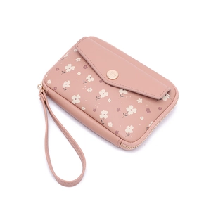 Detail of pink floral passport wallet showing gold snap button and leather wrist strap