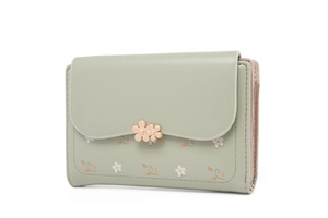 Detail view of mint green floral wallet with gold flower clasps and layered structure