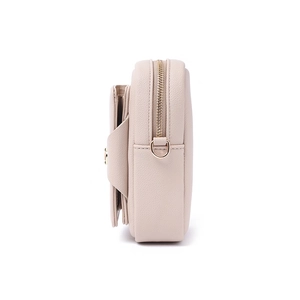 Detail view of pink pebbled leather belt bag showing zipper pocket and gold D-ring