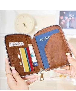 Detailed interior of a brown leather passport holder with card slots and zipper