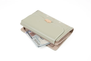 Detail of mint green floral wallet featuring gold flower accents and zip pocket