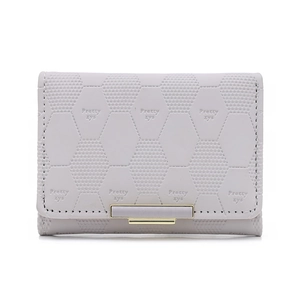 Close-up of lavender PU leather purse with hexagonal texture and golden metal buckle