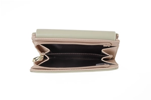 Detail view of the green floral wallet with two inner compartments and gold zipper closure