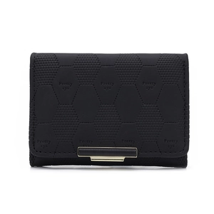 Detailed macro view of black PU leather wallet with a distinctive hexagonal texture
