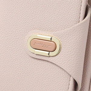 Detail of lychee pattern leather texture and golden metal swivel lock with engraving