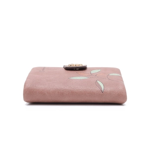 Detail of dusty pink leather folding wallet with leaf print and gold floral snap closure