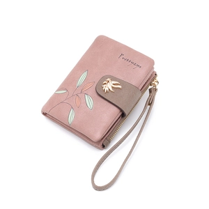 Detail view of mauve Prettyzys wallet with leaf print and gold hardware buckle