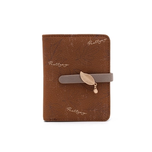 Detailed view of brown wallet featuring maple leaf texture and metal leaf pendant buckle
