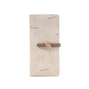 Detail of beige long wallet featuring leaf prints, Prettyzy logo, and golden leaf charm