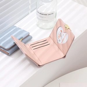 Detail of pink tri-fold wallet with card slots and a heart-shaped photo window