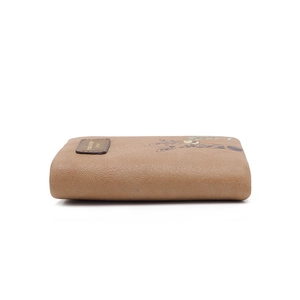 Close-up of brown textured leather wallet featuring a giraffe pattern and stitched label