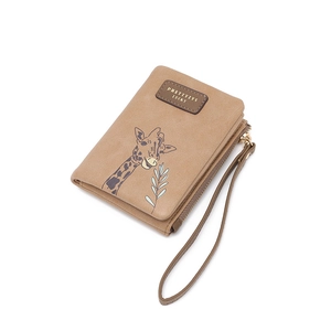 Close-up of faux leather coin purse featuring giraffe print and wristlet strap detail