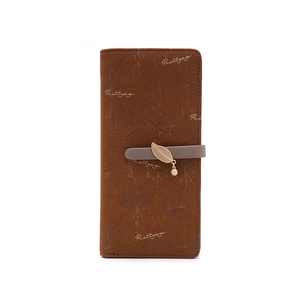 Close-up of brown long wallet with blue leaf prints and gold leaf metal charm detail