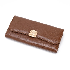 Detail of coffee brown long wallet featuring oil-wax leather texture and gold metal lock